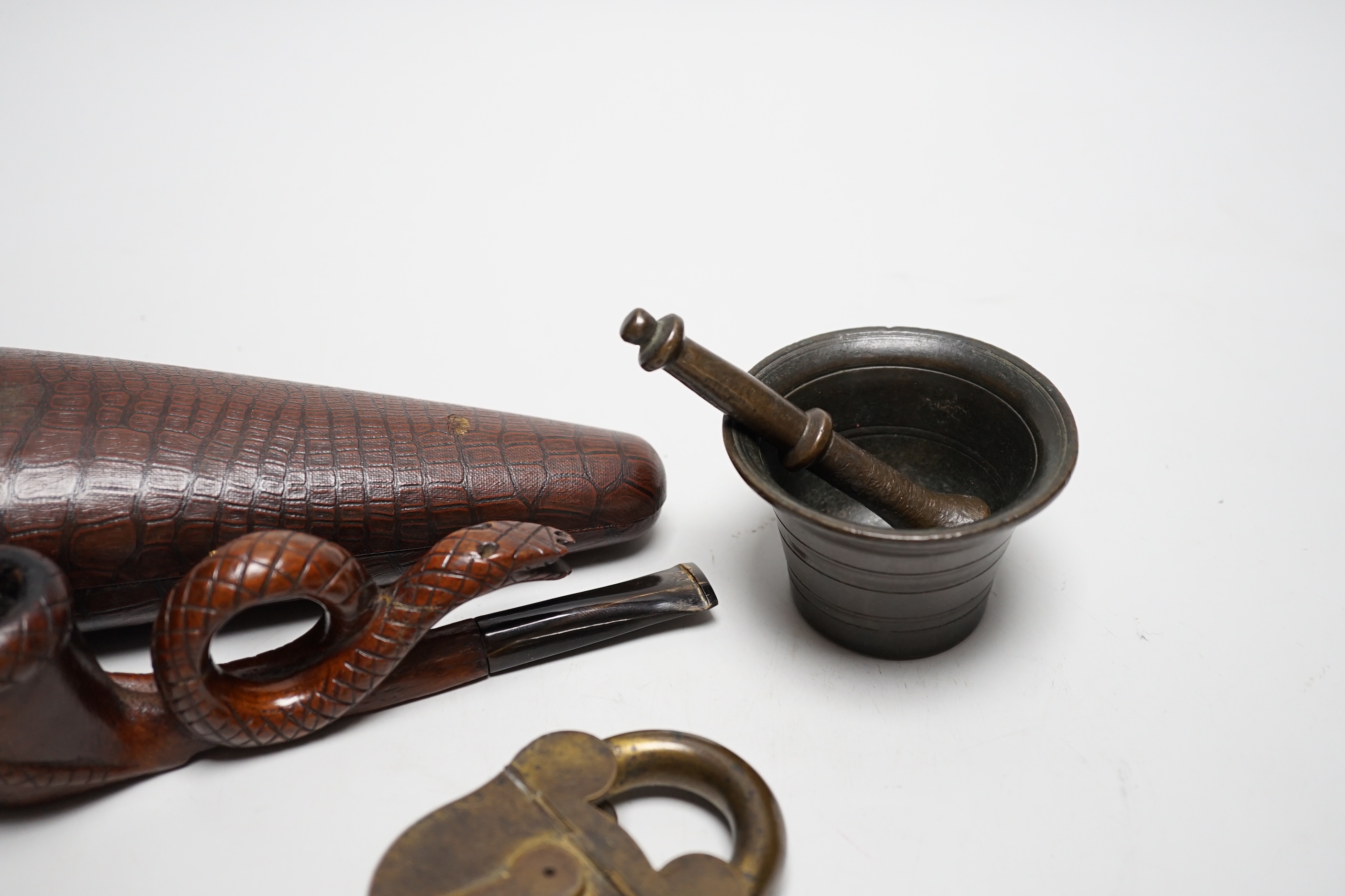A novelty cased pipe, a miniature pestle and mortar and a novelty vesta case